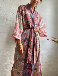 "This is one of a kind patchwork, upcycled silky robe Made free size with wrap tie closing and wide kimono sleeves  Easy and fun to wear around the house or outside as a urban boho style,  flowy kardigan with jeans and tshirt  It is very comfy and feels soft and light  the material is colourful and free flowing  made into this unique stylish over all MEAESURE free size length 55\" MATERIAL *polyester and silk *no lining more boho style ideas available at  https://www.etsy.com/shop/AltheaStores? CARE INSTRUCTIONS  * Wash in warm water * Hand wash recommended * Hang to dry  IMPORTANT NOTE  * Please note that colour shown on your monitor may vary from the colour of the fabric, due to light. If you have any doubts please contact us before purchuase." Urban Boho, Boho Robes, Patchwork Kimono, Silky Robe, House Coat, Mode Boho, Kimono Sleeves, Pajama Robe, Free Flowing