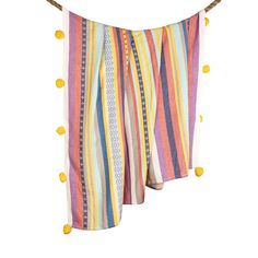 a multicolored towel hanging on a clothes line with pom - poms