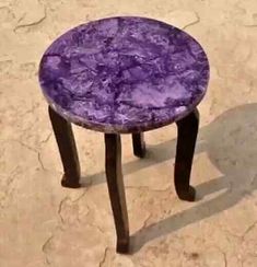 a small purple table sitting on top of a floor