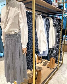 a woman's dress and shoes on display in a clothing store