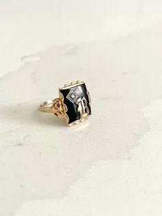 STUNNING bold and regal vintage yellow gold ring with a rectangular black onyx stone in the center and gorgeous scalloped ornate detailing beneath the gold pedestal holding the onyx up. The onyx bears a silver letter "B" on top with a small but mighty diamond stone in the corner. This is an incredible, highly sought-after art deco signet ring. This is estimated to be an antique piece. There is a symbol stamped inside the band beside which I cannot make out. This is presumably the maker's mark but possibly also the gold content. It appears to be a triangle, which apparently has roots in England and may even indicate a higher gold content, such as 14K. Size is approximately 6 - 6.25. Total weight is approximately 2.59 grams. *Note: This listing will ship with TRACKING to ALL destinations, in Black 14k Gold Engraved Jewelry, Engraved 14k Black Gold Jewelry, Engraved Black 14k Gold Jewelry, Vintage Black Enamel Ring For Anniversary, Black Enamel Ring In Fine Jewelry Style, Black Rectangular Signet Ring For Anniversary, Black 14k Gold Hallmarked Engraved Ring, Black 14k Gold Engraved Signet Ring, Vintage Black Enamel Signet Ring For Anniversary