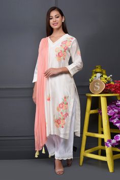 White straight long kurta with all-over floral motif applique-thread work. Comes with pants and contrast tassel dupatta.
Component: 3
Embroidered
Neckine: V Neck
Sleeve Length: Three Quarter
Fabric: Kurta and Pant: Silk Chanderi; Dupatta: Chiffon
Color: White
Side slits
Tassel dupatta
Scallop lace hem
Pleated neck and sleeve hem - Aza Fashions Chanderi Palazzo Set With Cutdana For Spring, Spring Chanderi Palazzo Set With Cutdana, Off White Silk Sets With Floral Embroidery, Cotton Silk Sharara With Straight Kurta For Spring, Spring Cotton Silk Sharara With Straight Kurta, Spring Chanderi Sharara, Spring Bollywood Cotton Silk Palazzo Set, Spring Bollywood Style Cotton Silk Palazzo Set, Traditional Cotton Silk Sharara For Spring