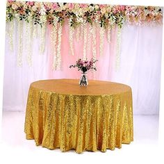 a gold sequin table cloth with flowers on it