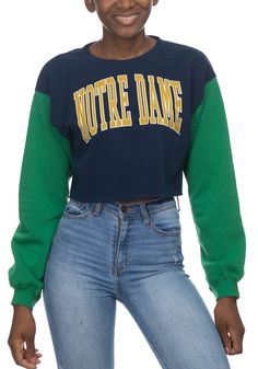 Make your way to the big game in this Notre Dame Fighting IrishWomens White Crop Colorblock Sleeve Crew Sweatshirt! This Fighting Irish Long Sleeve Sweatshirt features a screen print team name on center chest. Stay warm and comfortable with this Womens Fighting Irish Fighting Irish Crew Sweatshirt. Green Tops With Contrast Color For Fall, Green Contrast Color Tops For Fall, Winter Patchwork Tops For College, Green Winter Tops With Contrast Color, Winter Green Tops With Contrast Color, Green Contrast Color Tops For Winter, Trendy Green Top With Contrast Color, Crew Neck Sweatshirt With Splicing For Streetwear, Sporty Color Block Winter Tops