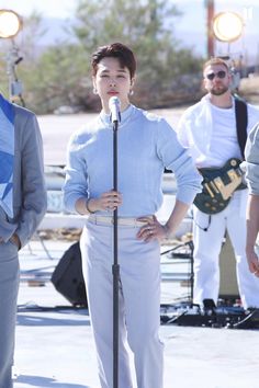 a woman standing in front of a microphone