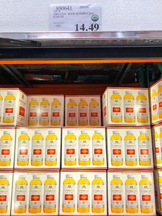 boxes of orange juice are stacked on top of each other in a store display case