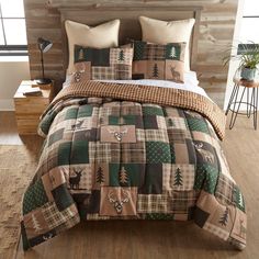 the bed is made up with plaid and deer designs on it, along with two pillows