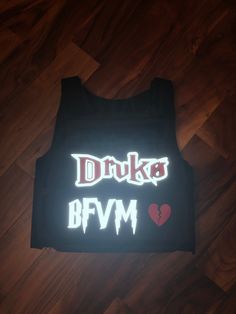 a tank top with the words drunk and bvm on it in white letters