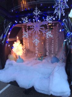 a car is decorated with snowflakes and lights