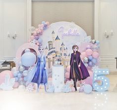 a barbie doll is standing in front of a backdrop with balloons and princesses on it