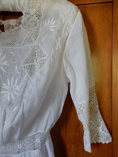 "This is a vintage antique cotton lawn Ladies Edwardian lace tea dress circa 1910 with many hand-embroidered details, lacework and pin tucks. It closes in the back with tiny pearl buttons ( one missing) and 6 little hooks. At the waist, there is a band of filet work, and there are 2 rows of filet crochet in the skirt as well as vertical pintucks for shaping. The front has 2 panels of Broderie Anglaise....beautiful flowers and insertions. The condition is good overall. The lawn cotton is strong w Classic Victorian Dress With Lace Trim For Spring, Vintage Cotton Victorian Wedding Dress, Cotton Vintage Dress With Lace Trim For Wedding, Vintage Cotton Wedding Dress With Lace Trim, Cotton Vintage Wedding Dress With Lace Trim, Summer Victorian Cotton Wedding Dress, Summer Wedding Victorian Cotton Dress, Vintage White Victorian Dress With Broderie Anglaise, Vintage Victorian Dress With Lace Patchwork