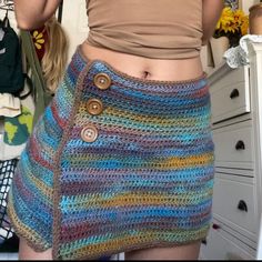 there is a woman wearing a multicolored skirt with buttons on the front and bottom