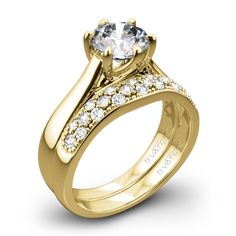 a yellow gold engagement ring with diamonds on it