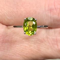 Genuine 1 Carat Peridot Oval Solitaire ~August Birthstone Ring ~ Dainty Engagement / Minimalist Fashion New! Retail Price: $119 Metal: Solid 925 Sterling Silver Finish: High Polish Hallmark: Stamped 925 Stone: Natural Peridot Stone Size: 8x6mm Stone Weight: 1.16 Carats Stone Shape: Oval Multiple Sizes Available August Birthstone Gift Box & Jewelry Cleaning Cloth Included! Perfect Genuine Gemstone Solitaire Ring! Dainty Ring Is A Perfect Everyday Fashion Or Trendy Engagement Ring! The Oval Shaped Oval May Birthstone Gemstone With Center Stone, Oval Peridot Gemstones For Anniversary, Green Oval Sterling Silver Birthstone Ring, Oval Peridot Birthstone Ring For Anniversary, Oval Peridot Ring In White Gold, Oval Birthstone Gemstones, Green Sterling Silver Oval Rings, Green Oval Sterling Silver Rings, Oval Lime Green Ring For Gift