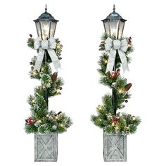 two christmas wreaths with lights and bows on them