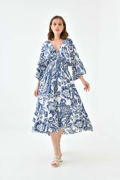 Say hello to our Oversized Flutter Sleeves Shirred Waist V Neck Midi Dress with Floral Print in Navy and White. With shirred waist an elegant mid length and flutter sleeves, this dress is perfect to wear at a wedding or a date night with that special someone. Match this dress with short heel sandals and a mini bag! SPECS: Material: Viscose Color: Navy Fit: Relaxed Size: Oversized *Suitable for UK size 8-16 Product Highlight: ● Oversized fit with details. ● Versatile design. ● Suitable for various occasions. ● Flattering fit. ● A versatile addition to your wardrobe. 💦CARE INSTRUCTIONS: ● Check the care label for instructions. ● Pre-treat stains before washing. ● Machine wash on a gentle cycle with cold water. ● Use a mild detergent suitable for delicate fabrics. ● Avoid bleach and fabric s Vacation V-neck Midi Dress With Gathered Sleeves, Beach Midi Dress With Gathered Sleeves And V-neck, Beach V-neck Dress With Gathered Sleeves, Flowy Empire Waist Dress For Vacation, Beach Dress With Gathered Sleeves And V-neck, V-neck Midi Dress With Gathered Sleeves For Vacation, Flowy Midi Dress With Gathered Sleeves For Vacation, Vacation Dress With Gathered Long Sleeves, Long Sleeve Dress With Gathered Sleeves For Vacation