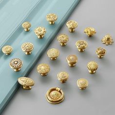 many different types of knobs and handles on a gray surface with a blue background