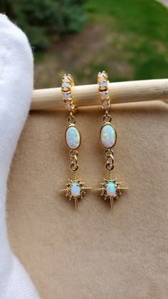 Starburst Opal Earrings  Gold huggie earrings with beautiful shine and a great celestial vibe.  Earrings: ~ 14k Gold Plated ~ With Opal Accents (the opals are synthetic man-made) 👉 Link to Our STOREFRONT: https://www.etsy.com/shop/FashionCrashJewelry?ref=shopsection_shophome_leftnav&ga_search_query=crystal%2Bnecklace Our Motto ~ Happy Customers Are Awesome 🌞Let us know of any problems or concerns with purchases. 🌞 5star reviews and positive comments are greatly appreciated, they help the succ White Sparkling Hoop Earrings As Gift, White Sparkling Hoop Earrings For Gift, Sparkling White Hoop Earrings As Gift, Celestial White Earrings, White Celestial Star Earrings, Celestial White Star Earrings, White Celestial Earrings For Gift, Gold Huggies, Halloween Necklace