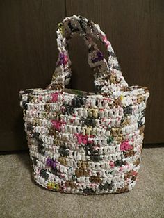 a multicolored handbag sitting on the floor