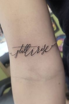 a woman's arm with the word faith written in cursive writing on it