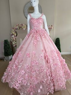 a mannequin dressed in a pink dress with flowers on it's skirt