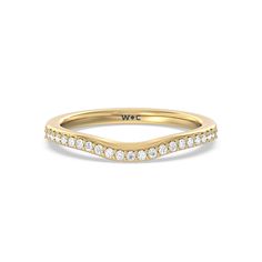 a yellow gold wedding band with white diamonds on the sides and a curved design in the middle