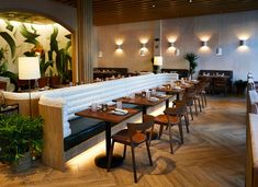 an empty restaurant with wooden tables and chairs