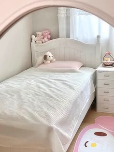 a small child's bedroom with white furniture and pink rugs on the floor