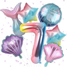 the number seven balloon bouquet is filled with helium balloons and mermaid tailes, all in pastel colors