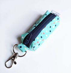 "The perfect little box pouch to hold your lip balm. Also great for holding other small items you want to keep safe and close-by...flash drives, ear buds, car key fobs, travel pill containers, essential oil bottles, etc. This pouch is unlined but fully interfaced to give it shape. One end is a tabbed key clip and the other a piece of twill tape to make zipping easy. Use the key clip to hang from your key ring, bag, or other handy spot. Approximate dimensions: 3\" long x 1\" wide x 1\" tall Pattern placement may differ on yours. Last picture is for size reference. Ready to ship! Want to add a lip balm to your pouch purchase? They're perfect for gifting together! https://www.etsy.com/listing/917997684/beeswax-lip-balm?ref=shop_home_active_1 Interested in 10 or more lip balm pouches at wholes Functional Pencil Case With Zipper Closure As Gift, Functional Rectangular Pencil Case Gift, Functional Rectangular Pencil Case As Gift, Functional Portable Pencil Case For Gift, Functional Portable Pencil Case As Gift, Functional Coin Purse With Zipper Closure As Gift, Clip Keychain, Pill Container, Beeswax Lip Balm