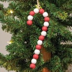 a christmas ornament hanging from the top of a tree with candy canes on it