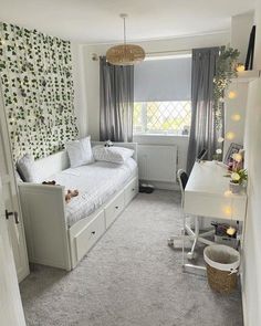 a bedroom with a bed, desk and chair next to a wallpapered wall