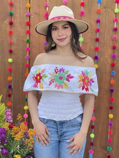 This Beautiful Off the Shoulder Crop Top is the perfect Top for a fun day out. It's made out of cotton, has an elastic waist and is full of vibrant hand embroidered florals. Please note: This blouse comes in one size which fits sizes Small and Medium. This blouse is hand embroidered and the embroidered colors vary on each blouse making each blouse one of a kind. You may purchase the jewelry in a variety of colors and styles found in another post. Blouse Crop Top, Blouse Crop, Mexican Fashion, Mexican Blouse, Embroidered Crop Tops, Off The Shoulder Blouse, Plunge Dress, Star Dress, Fashion Blouse