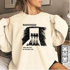 a woman wearing a white shirt with the words radiohead on it