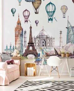 the wallpaper in this living room has many hot air balloons flying over the city