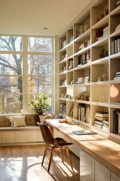 a home office with lots of bookshelves and windows