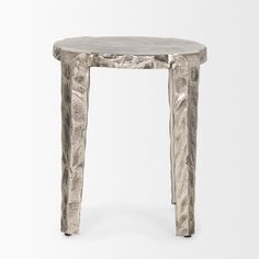 a small table made out of metal with an artistic design on the top and bottom