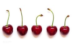 four cherries are lined up in a row