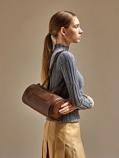 Editor's NotesThis bag from moiqui adds a casual mood to your outlook.- Trapezoid cylindrical silhouette- Thick and soft piping on both sides- Comfortable to wear with the layered shoulder strap- Zipper pocket on the backMeasurements(in.)- Size: 10.24 in. * 5.91 in. * 5.91 in.- Handle Drop: 12.20 in.Composition & Care- Vegan Leather- Avoid direct heat and moisture- In case of contamination, partial washing with neutral detergentDesigner- by moiqui Brown Satchel With Rolled Handles, Brown Satchel Bucket Bag With Rolled Handles, Brown Workwear Bags With Rolled Handles, Brown Shoulder Bag With Rolled Handles For Work, Brown Bucket Shoulder Bag With Rolled Handles, Piping, Zipper Pocket, Vegan Leather, Shoulder Strap