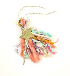 an ornament with feathers and a star on it