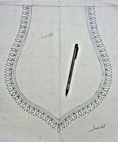 a pen sitting on top of a piece of paper with an intricate border around it