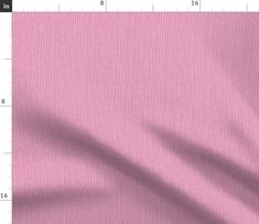 a close up view of a pink fabric with a ruler in the foreground and an area for text