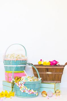 three buckets filled with candy sitting next to each other on top of a table