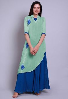 Faux Georgette Layered Kurta in Sea Green and Teal Blue. This Readymade attire with Shantoon Lining is Enhanced with Resham Work and is Crafted in Chinese Collar Neck and Elbow Sleeve. Available with a Lycra Leggings in Teal Blue. For Sizes 46 to 66, a matching shantoon churidar will be available having length 50 inches. Do note: Accessories shown in the image are for presentation purposes only and length may vary upto 2 inches.(Slight variation in actual color vs. image is possible).  We sell a Kurtis Indian, Layered Kurta, Indian Tops, Angrakha Style, Resham Work, Lycra Leggings, Chinese Collar, Utsav Fashion, Collar Neck