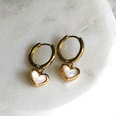 Classic and timeless these gold hoops are perfect everyday earrings.  D E T A I L S These everyday earrings are high quality 18kt Gold Filled huggie hoops, 15mm. Adorned with a mother of pearl, gold plated heart drop ∙ EXTRA LOVE ∙ Crafted with hand & heart just for you in the desert of our Arizona studio. All of our jewelry comes gift packaged! We are happy to leave a note if this is a special gift, just let us know in the message box at checkout. ∙ PRODUCTION TIMES ∙ Each design is handcrafted Gold Hoops With Charms, Anniversary Small Hoop Huggie Earrings With Heart Charm, Valentine's Day Small Hoop Huggie Earrings With Heart Charm, Gold Heart Earrings As A Gift For Her, Gold Heart-shaped Earrings As Gift For Her, Gold Heart Earrings Gift For Her, Gold Heart-shaped Earrings For Her, Anniversary Huggie Hoop Earrings With Heart Charm, Valentine's Day Nickel-free Huggie Hoop Earrings