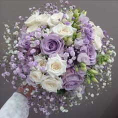 a bridal bouquet with purple and white flowers