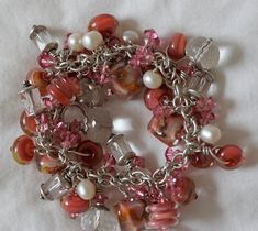 Please read entire description: Huge chunky charm style bracelet with Artisan Boro (borosilicate) Glass beads from one of my favorite bead makers. The glass beads are pinky-peachy-apricot colored. The clear beads are all faceted Quartz Crystal beads, freshwater pearls, Swarovski beads, and lots of sterling silver. Will fit a 7 to 7-1/2 wrist size (length 8 inches), and it's hefty weight is 95 grams. Length: 8 inches - due to the amount of beads size down to 7 1/2 inches  Clasp: toggle* Total wei Handmade Chains, Apricot Blush, Clear Beads, Swarovski Beads, Bold Jewelry, Jewelry Boards, Christmas Bracelet, Crown Jewels, Beaded Hoop Earrings