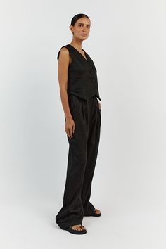 The Sleeveless Linen Vest Pant Set is a timeless ensemble that ties sophistication with comfort. This set is composed of a sleeveless linen vest that boasts a sharp V-neckline and button-down front, paired with coordinating wide-leg pants that offer a relaxed fit. This set encapsulates an effortless elegance, ideal for those who appreciate a minimalist aesthetic with a touch of classic charm! Features: Light & Soft Linen A lightweight textured linen material with soft lining adapts to any style Black Linen Pants, Linen Vest, Comfy Jumpsuits, Sleeveless Vest, Black Linen, Knit Set, Pant Set, Cozy Knits, High Waisted Trousers