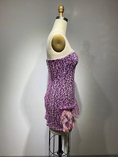 a mannequin with a purple dress on display