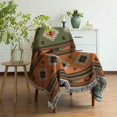 a living room with a couch, table and potted plant